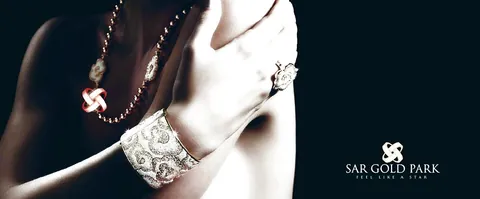 SAR Gold Park campaign photograph of hands wearing an ornate gold bangle