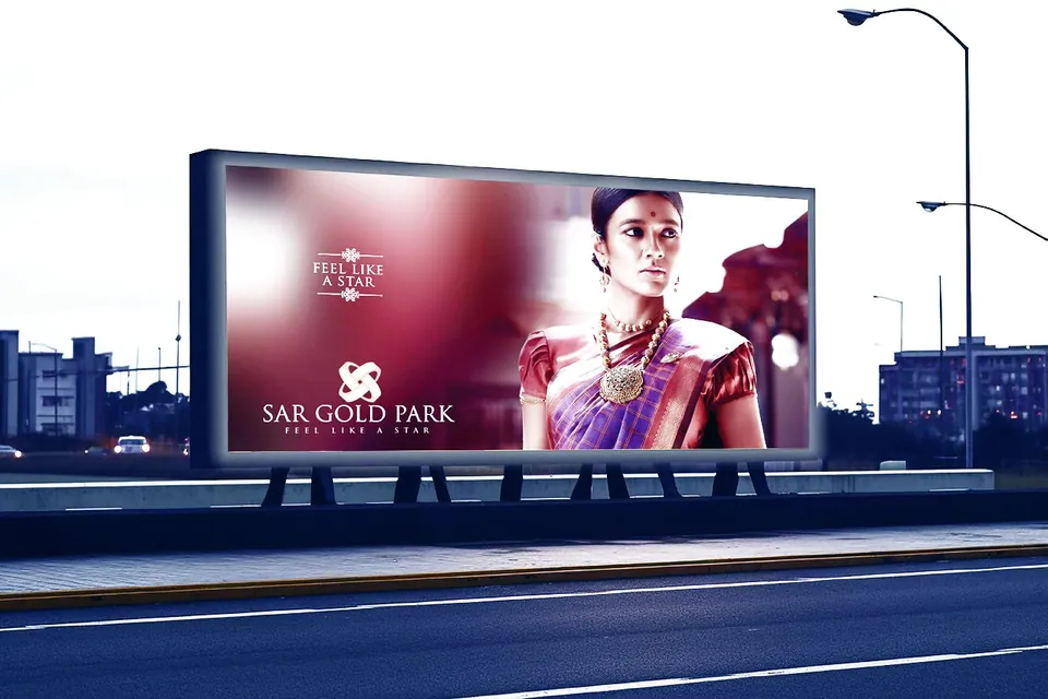 SAR Gold Park hoarding beside a highway at dusk, a model in a silk saree and gold