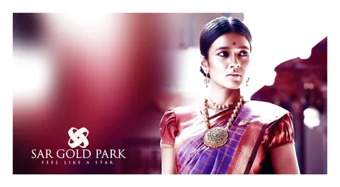 SAR Gold Park campaign photograph of a woman in a red silk saree and gold jewellery